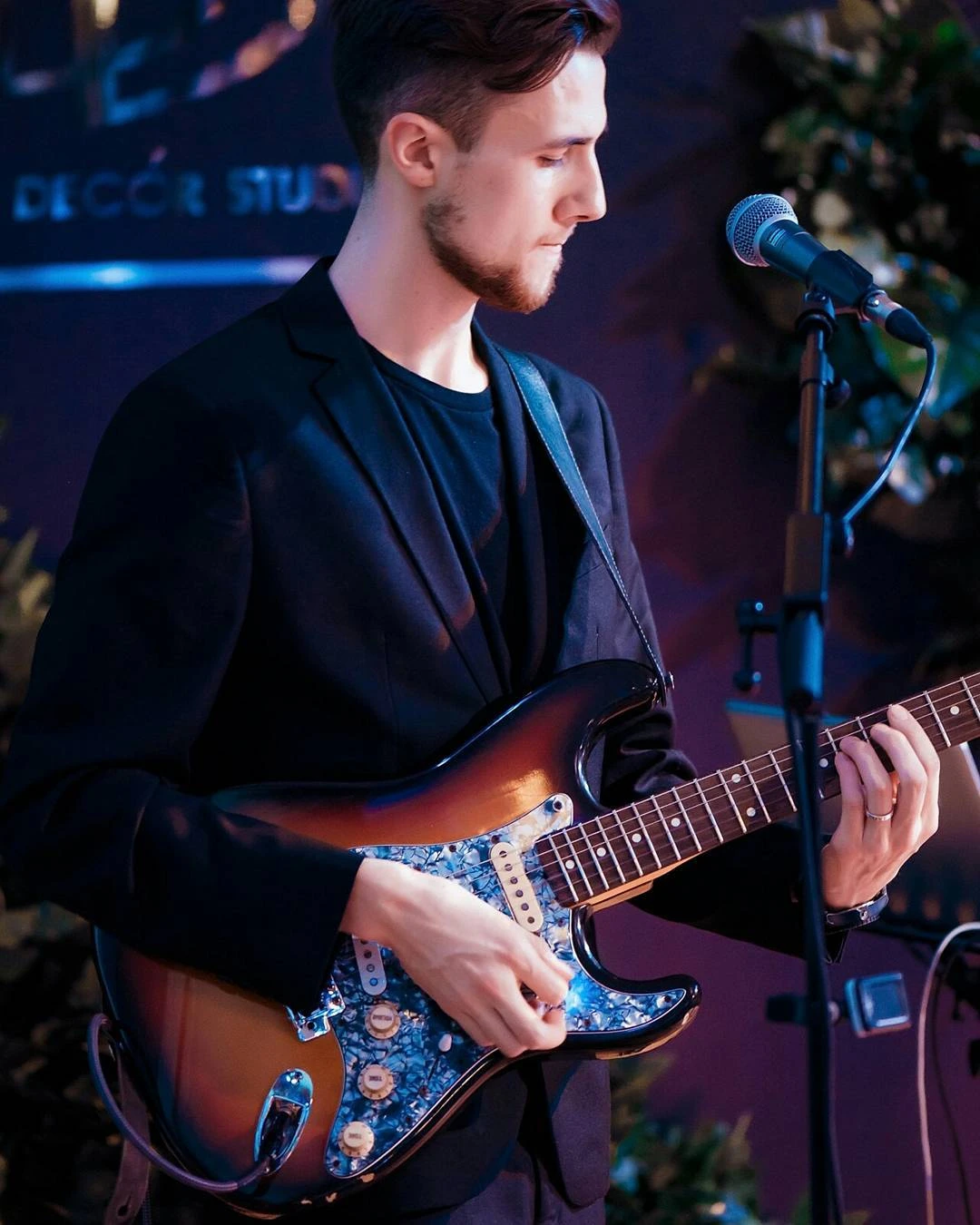 Roman playing guitar at a live show